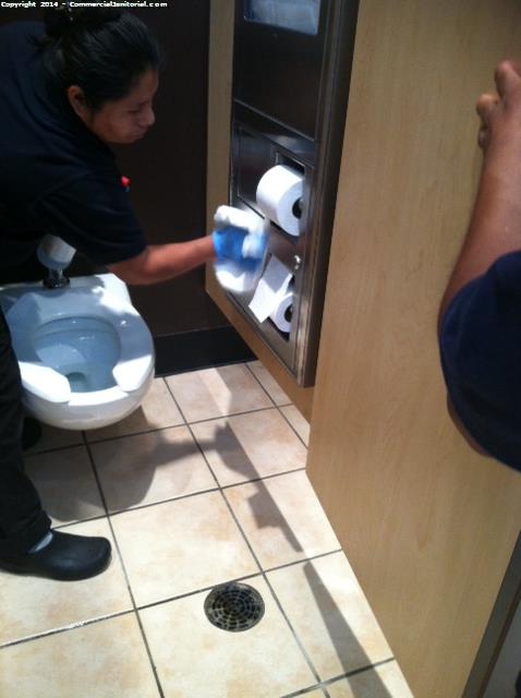 Janitor in action when cleaning a restroom at a bar