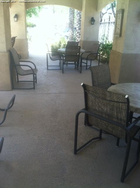 Cleaning patio chairs and tables as part of exterior porter services