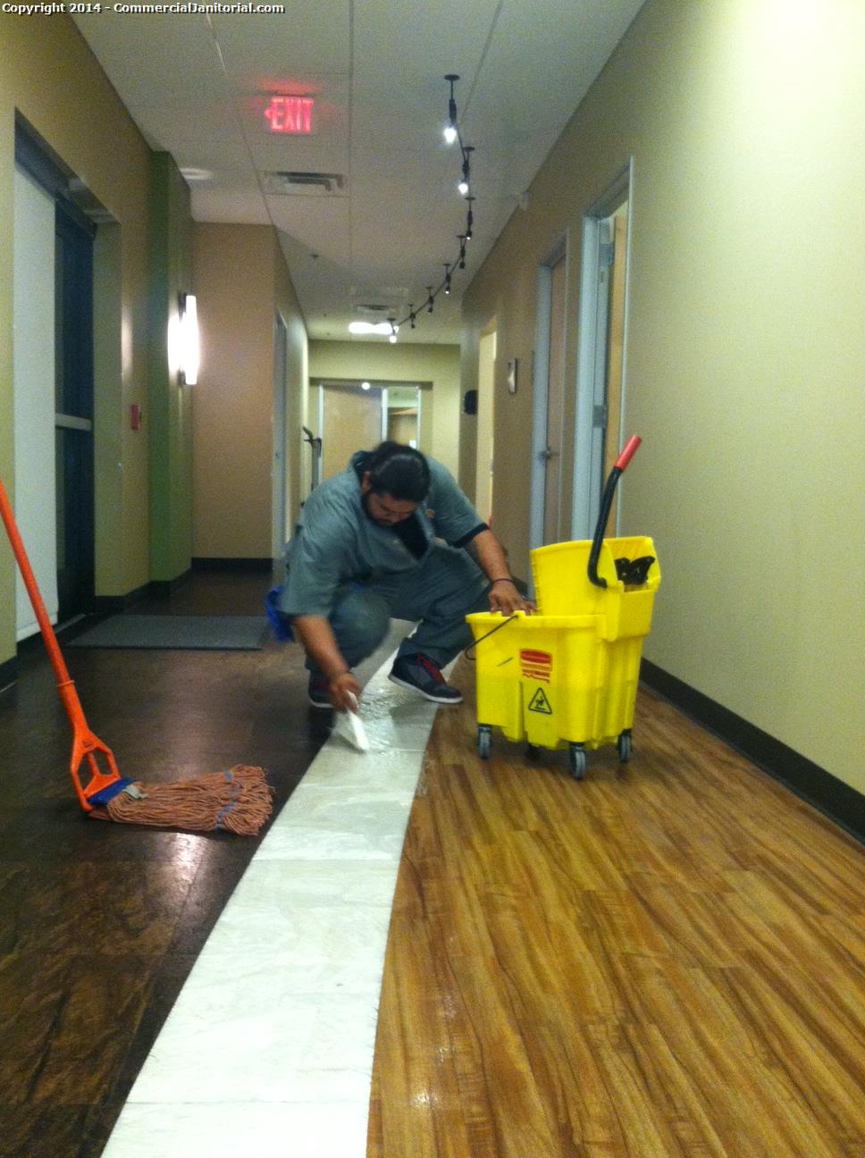 Floor crew Hand scrubbed all of the white pearl VCT all around the building 