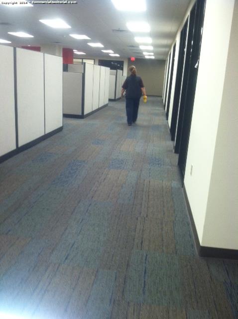 Cleaner walking down a hallway to their next cleaning task