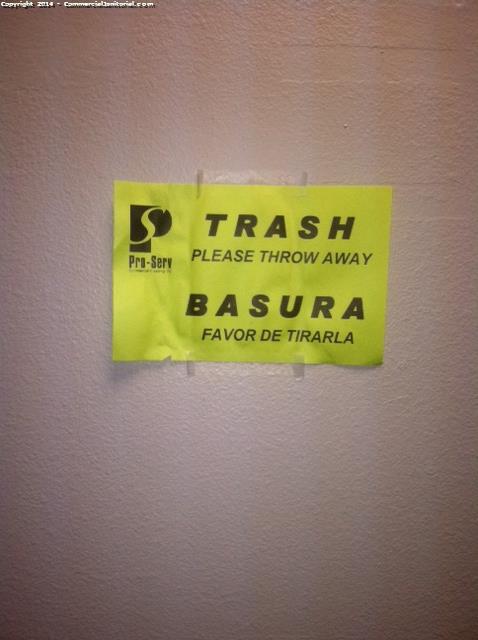 There is a sign put on the wall to indicates the night crew where the trash belongs 