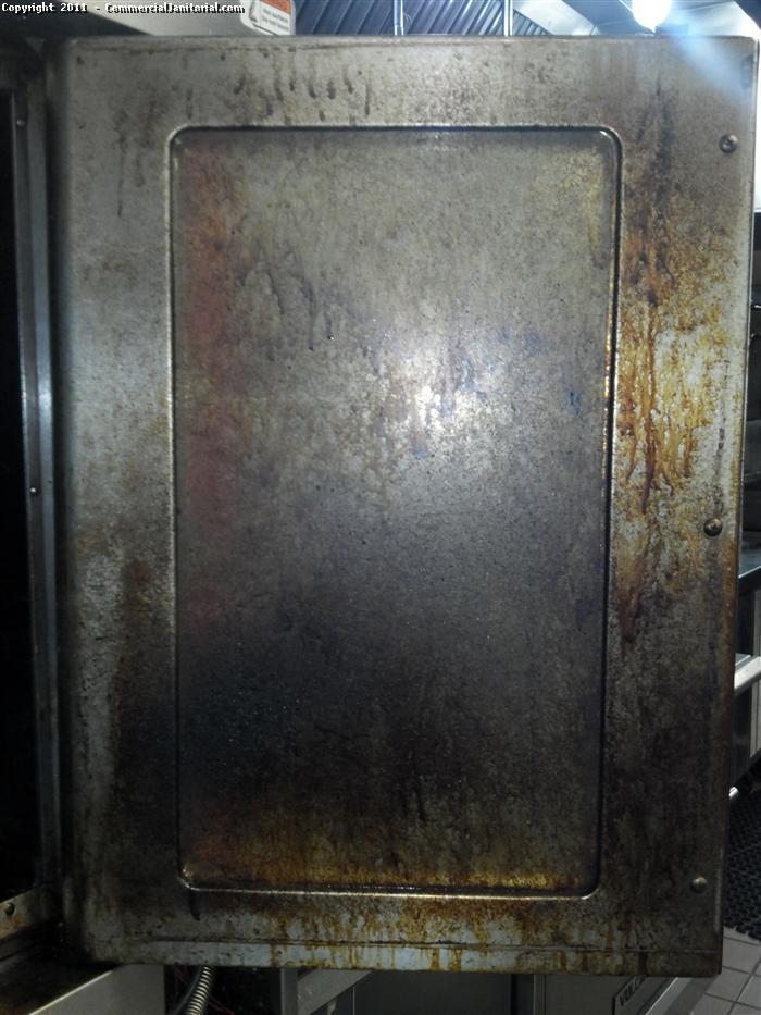 Commercial kitchen and restaurant cleaning. This is a before picture of an oven door. This door has not been cleaned properly in some time.