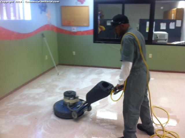 Floor scrubbing performed inside educational facility 