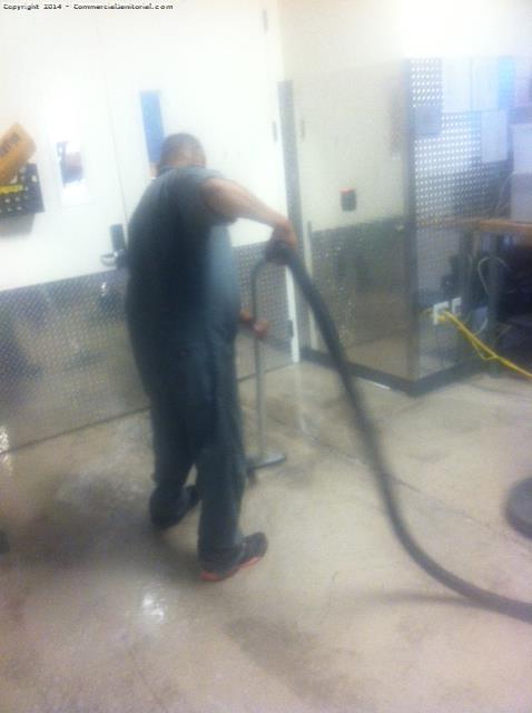 Our crew vacuuming dirty floor solution